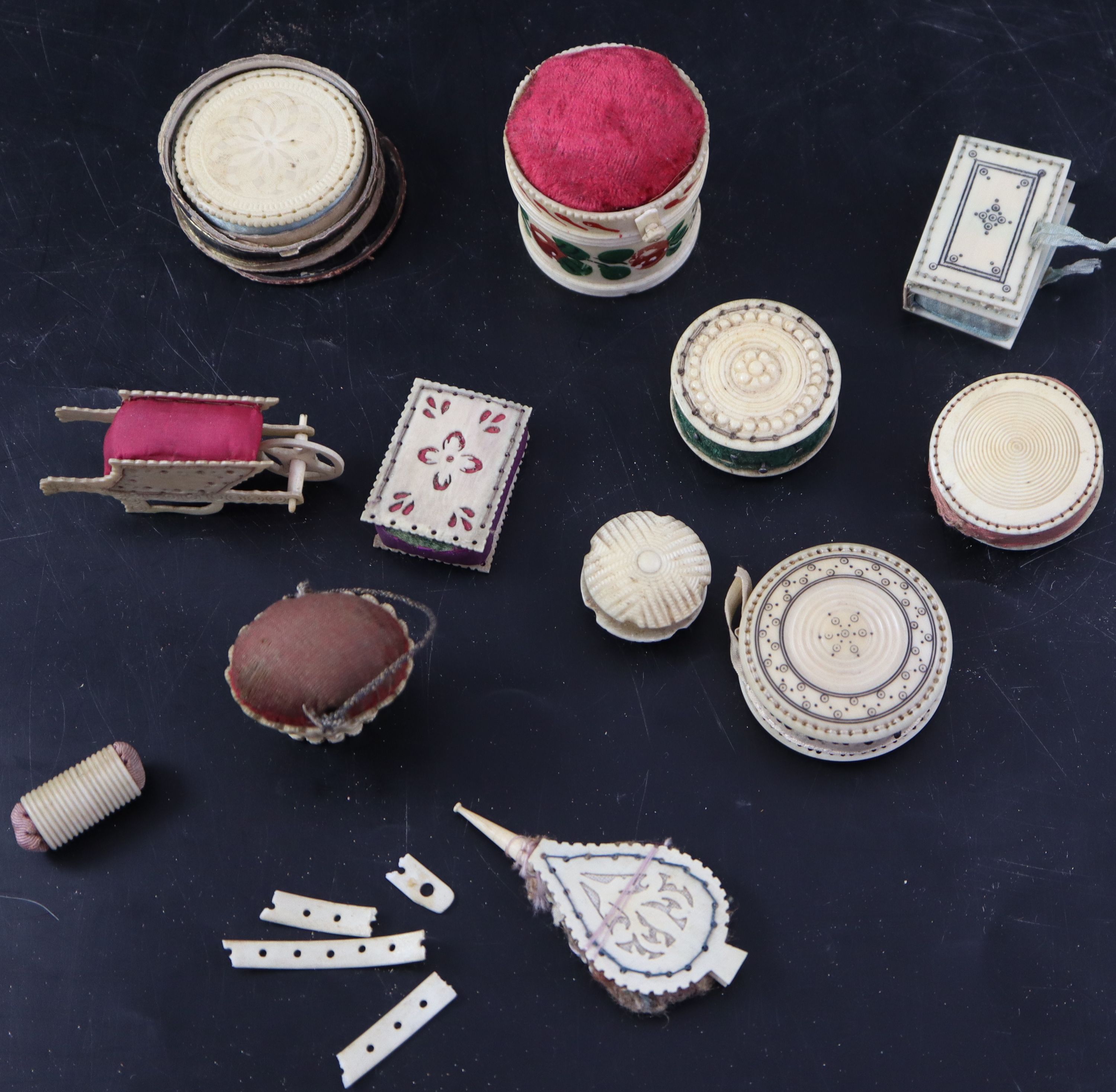 A collection of twelve 19th century carved ivory and bone pin cushions